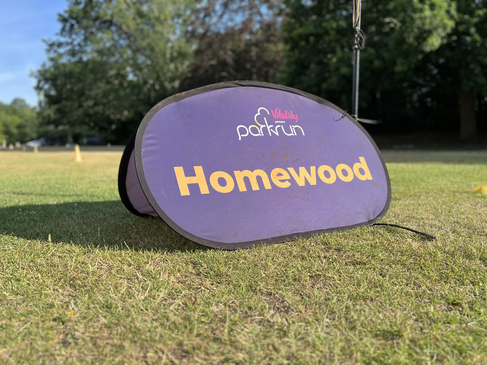Homewood parkrun event sign on the playing fields at Ottershaw Memorial Fields